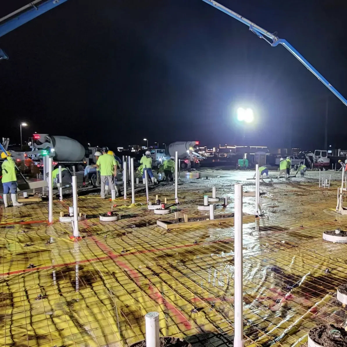 Group of Men working on a commercial concrete pour at night